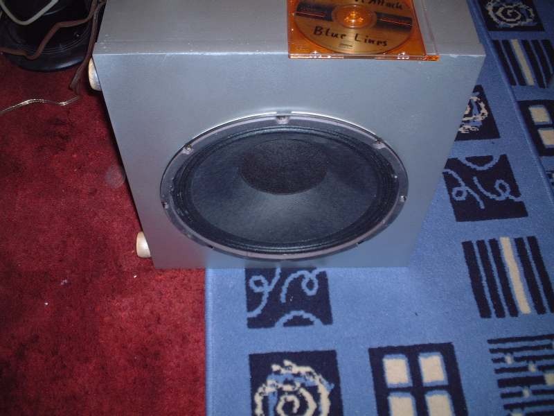 Photograph: a 12 in woofer in a silver box