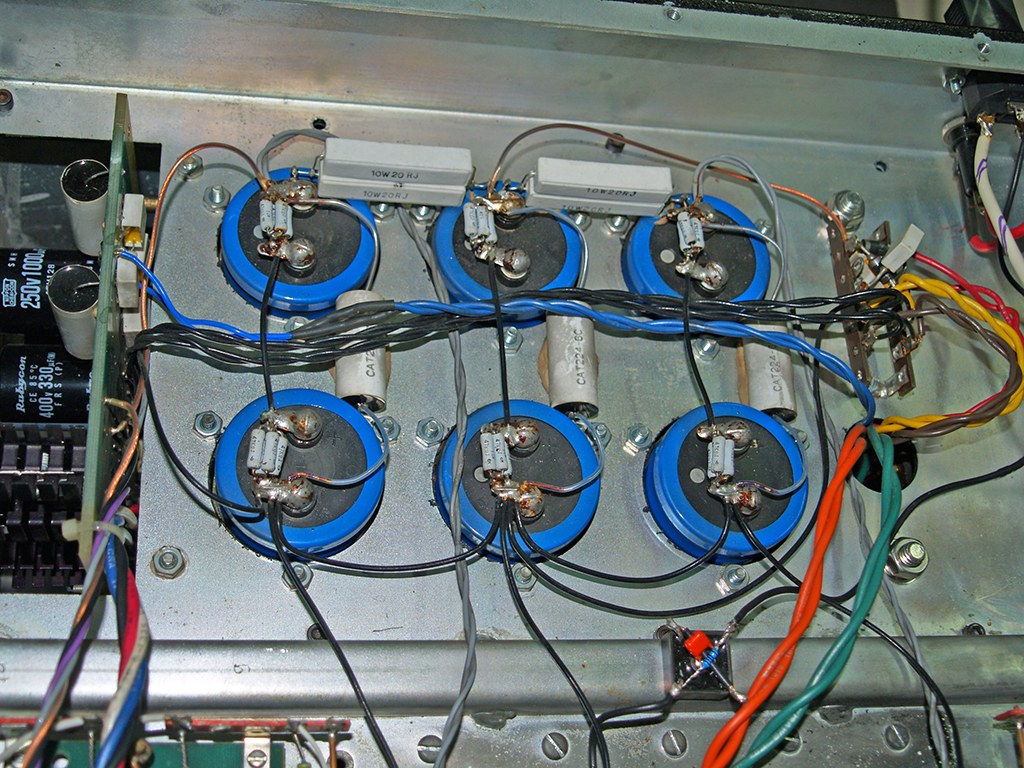 Photograph: a bank of large blue capacitors mounted on the chassis